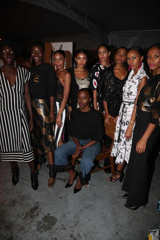 Undra Celeste, sitting here like a boss, with models wearing her designs (Johnny Nunez)